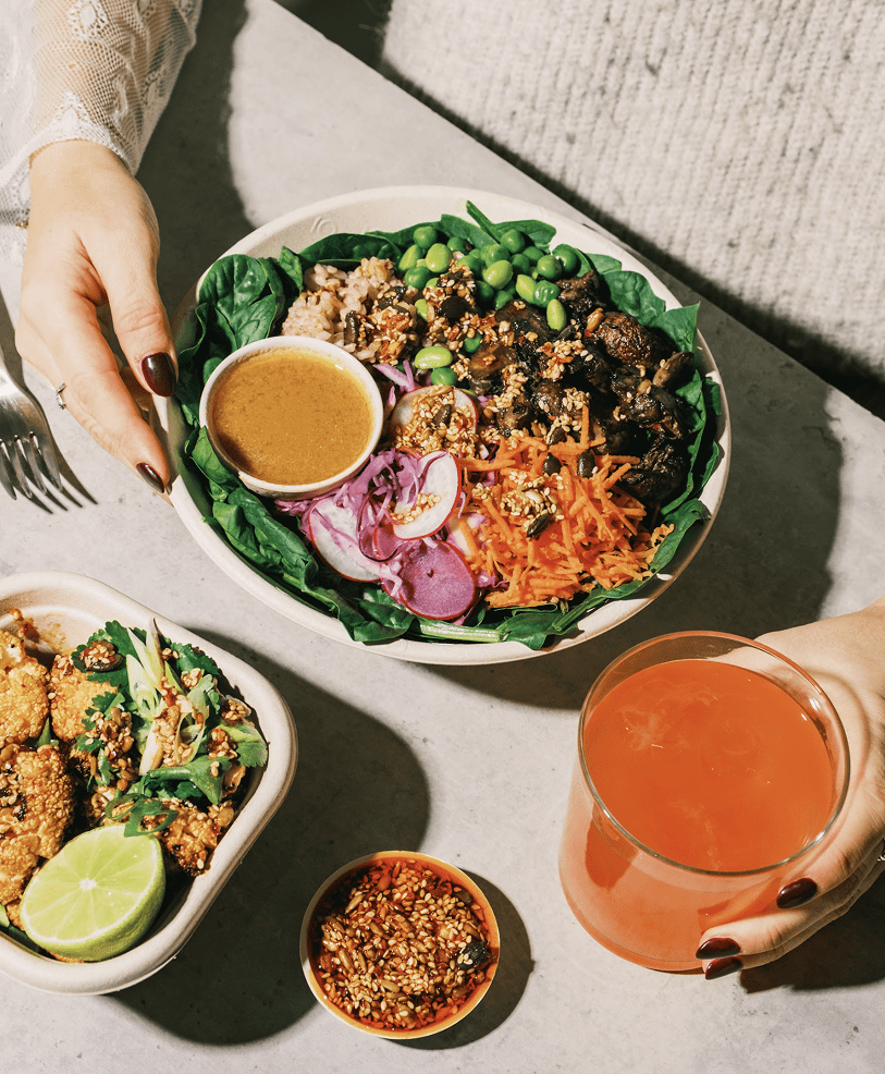 Colourful atis bowl with edamame, pickled veg and miso dressing, served with a cauliflower pot and iced drink